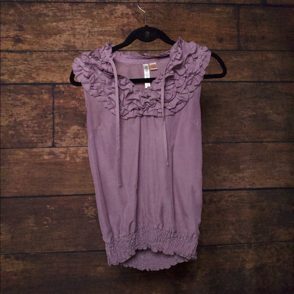 A purple shirt with frill at the bottom and top